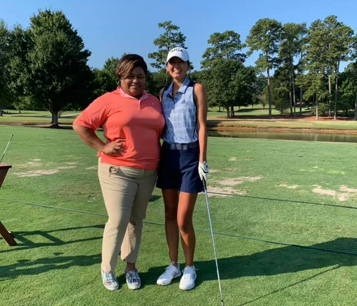 two golfers posing